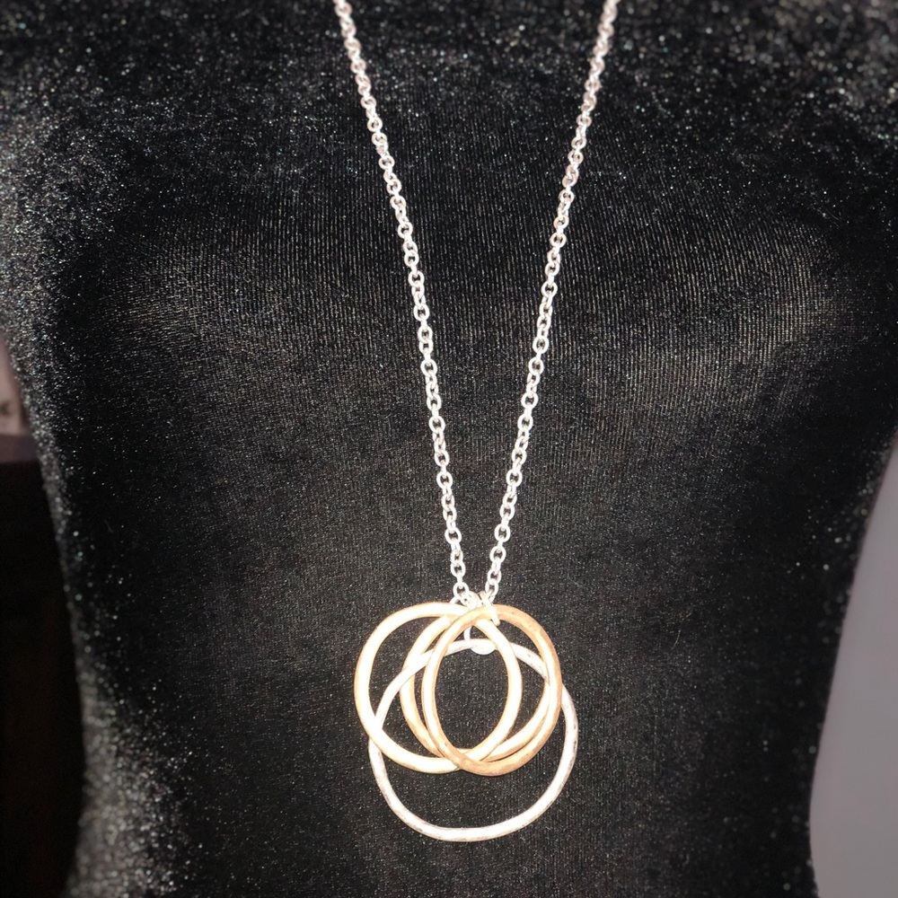 Silver tone necklace with gold and silver circle